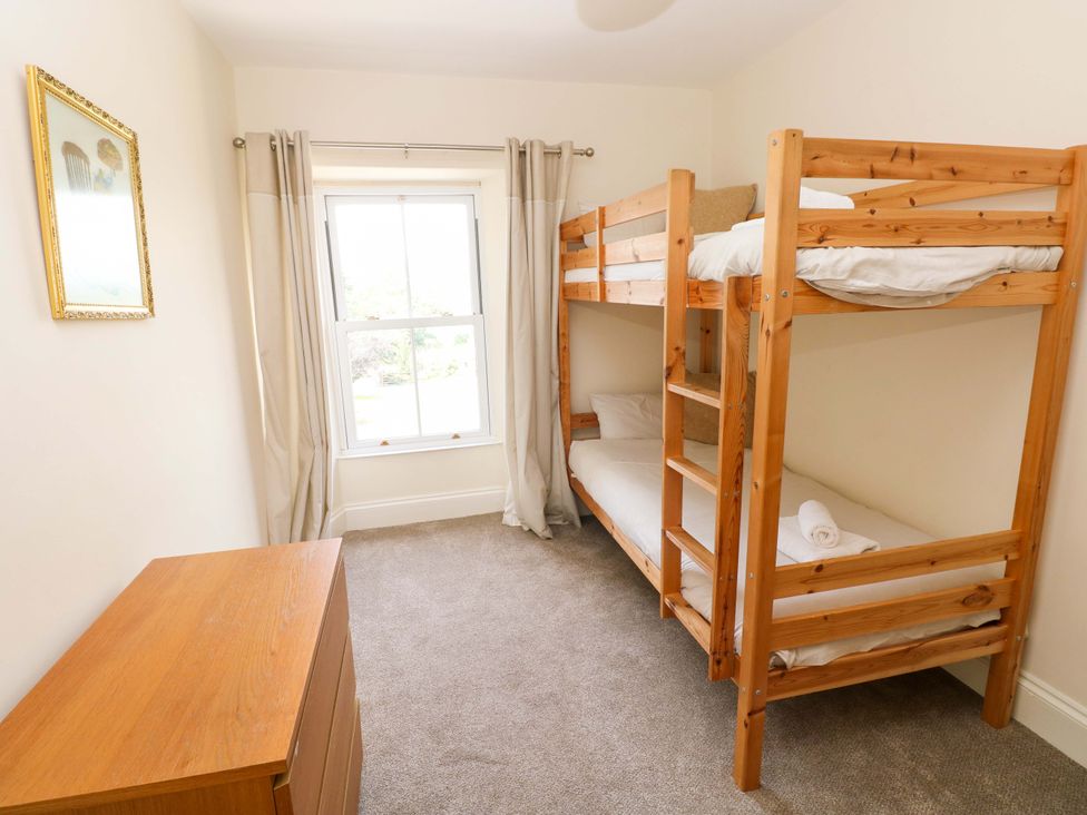 A bedroom with a bunk bed and dresser at The Sycamores Llawhaden near Narberth