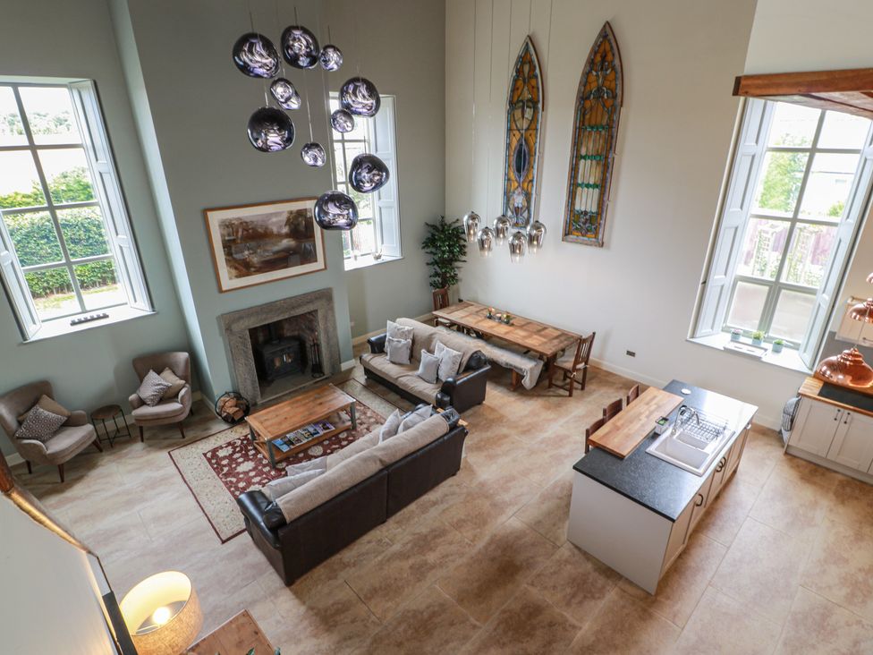 A living room with sofas and a dining area at The Old Chapel in Norham