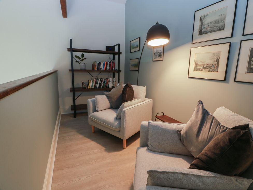 A snug area with bookshelves and sofas at The Old Chapel in Norham