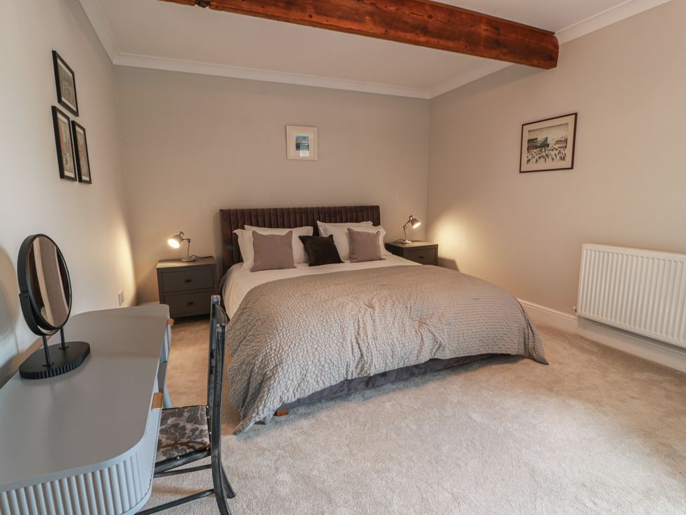 A bedroom with a bed and desk at The Old Chapel in Norham