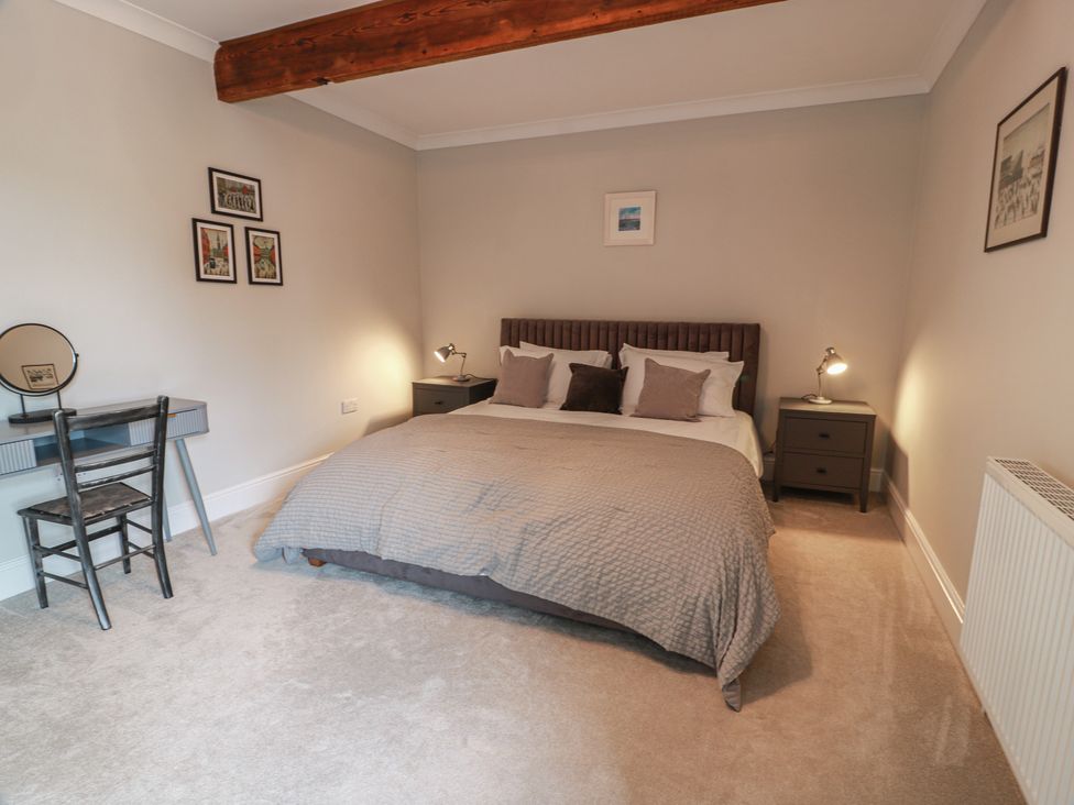 A bedroom with a bed and a desk at The Old Chapel in Norham