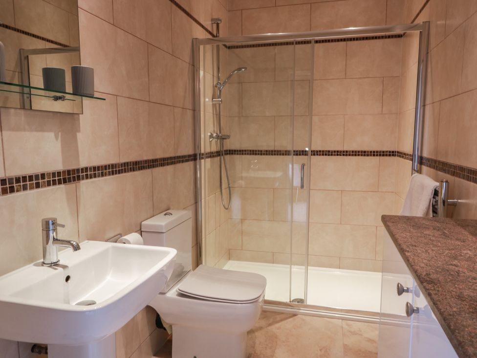 A bathroom with a sink, toilet, and shower at The Old Chapel in Norham
