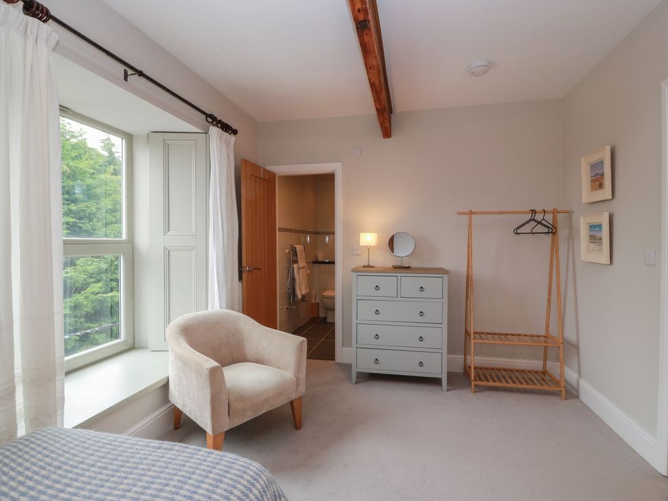 A bedroom with a window and dresser at The Old Chapel in Norham