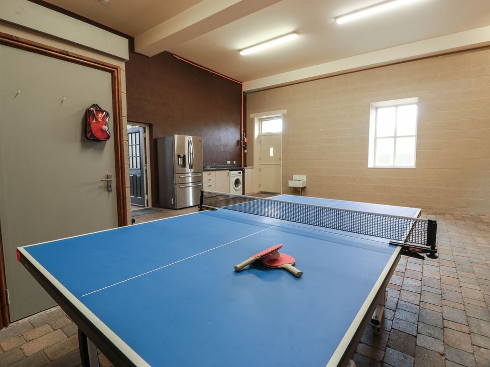 A game room with a ping pong table and appliances at The Old Chapel Norham