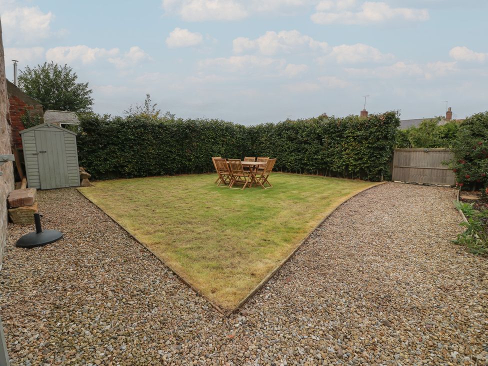 A garden with a table and chairs at The Old Chapel in Norham