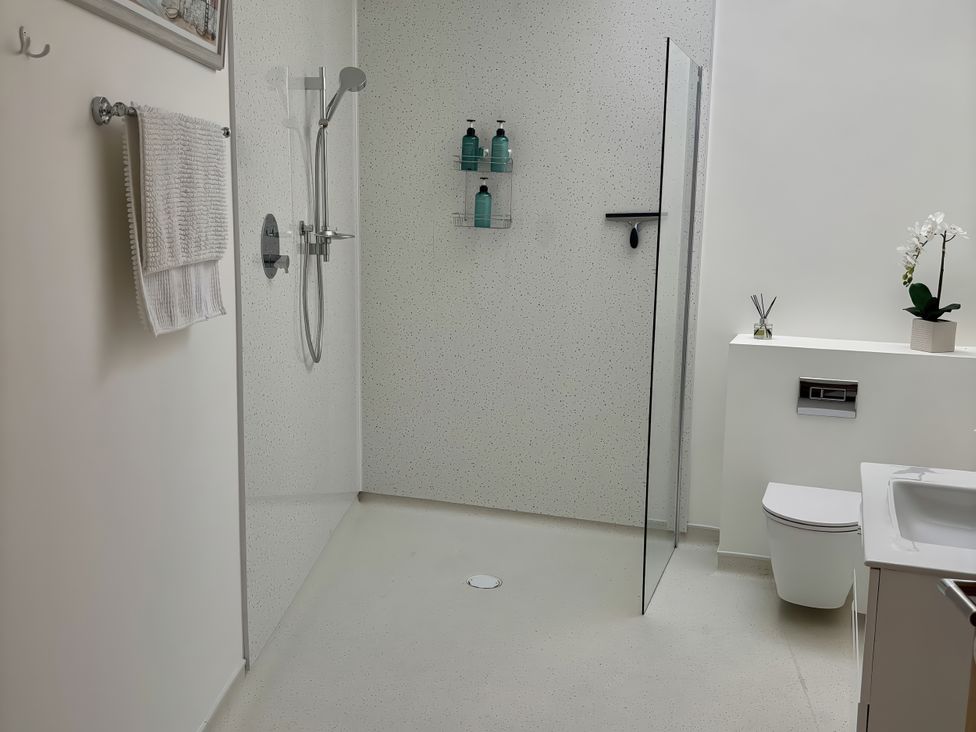A bathroom with a shower and sink at 8 Church Road Ferndown
