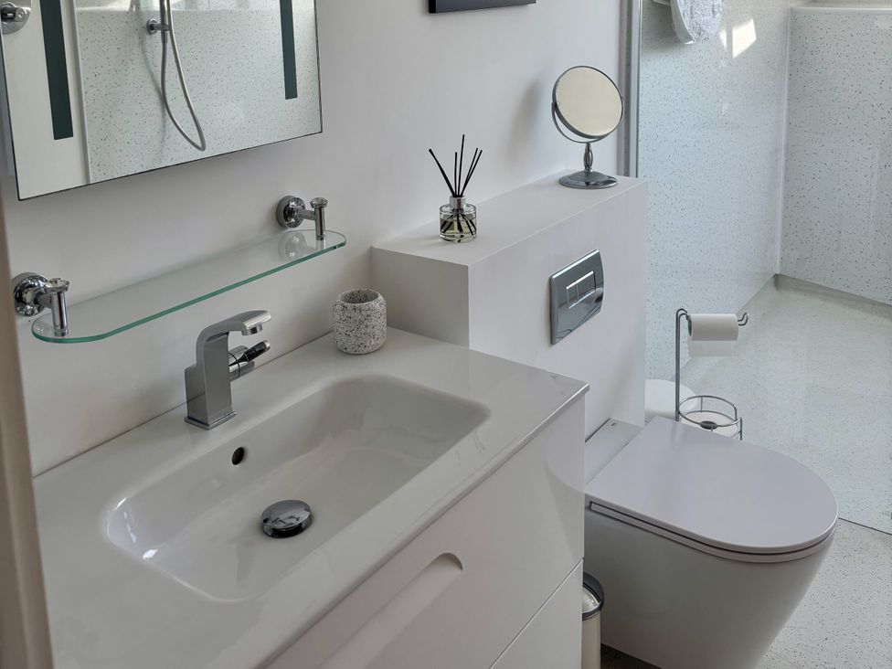A bathroom with a sink and toilet at 8 Church Road, Ferndown