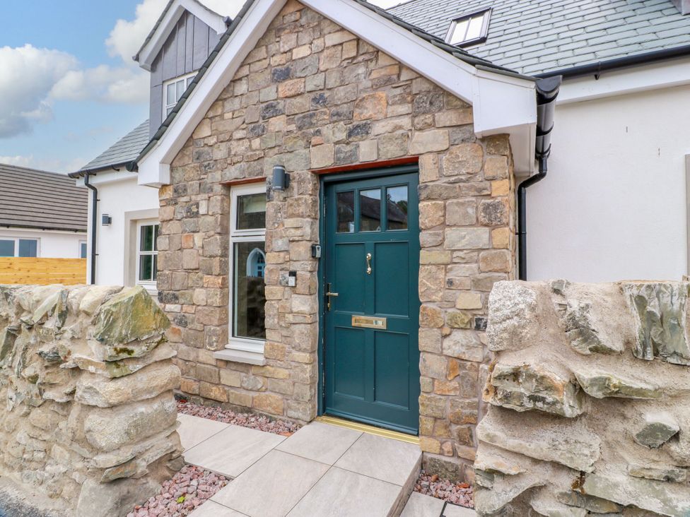 An entrance with a stone wall and front door at Riverwood House in Gatehouse Of Fleet