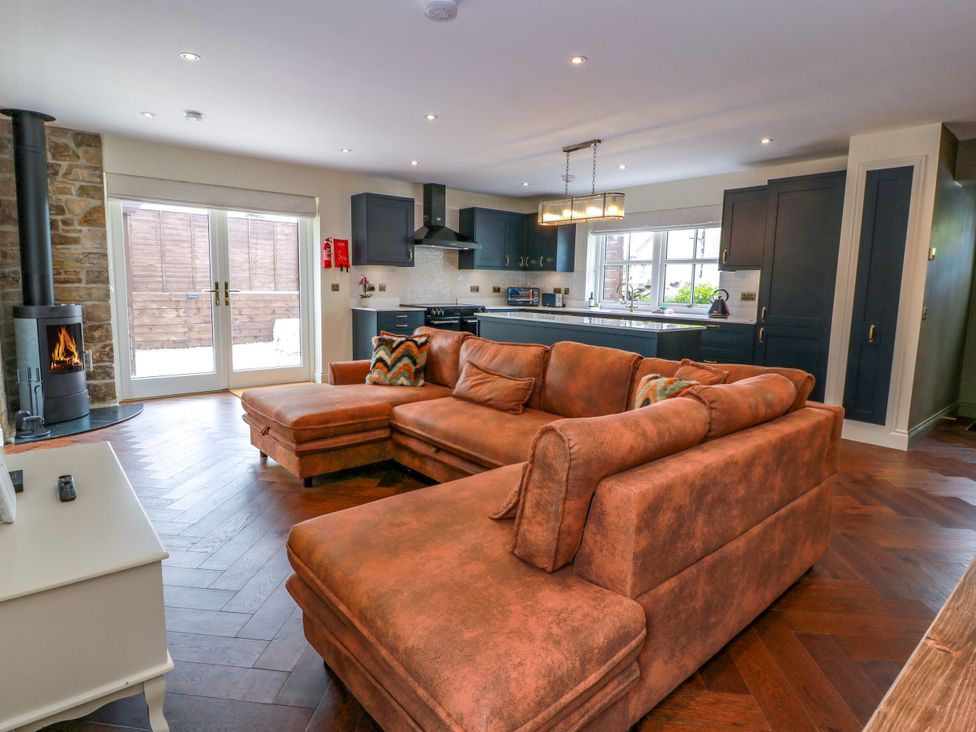 A living room with a couch and fireplace at Riverwood House Gatehouse Of Fleet