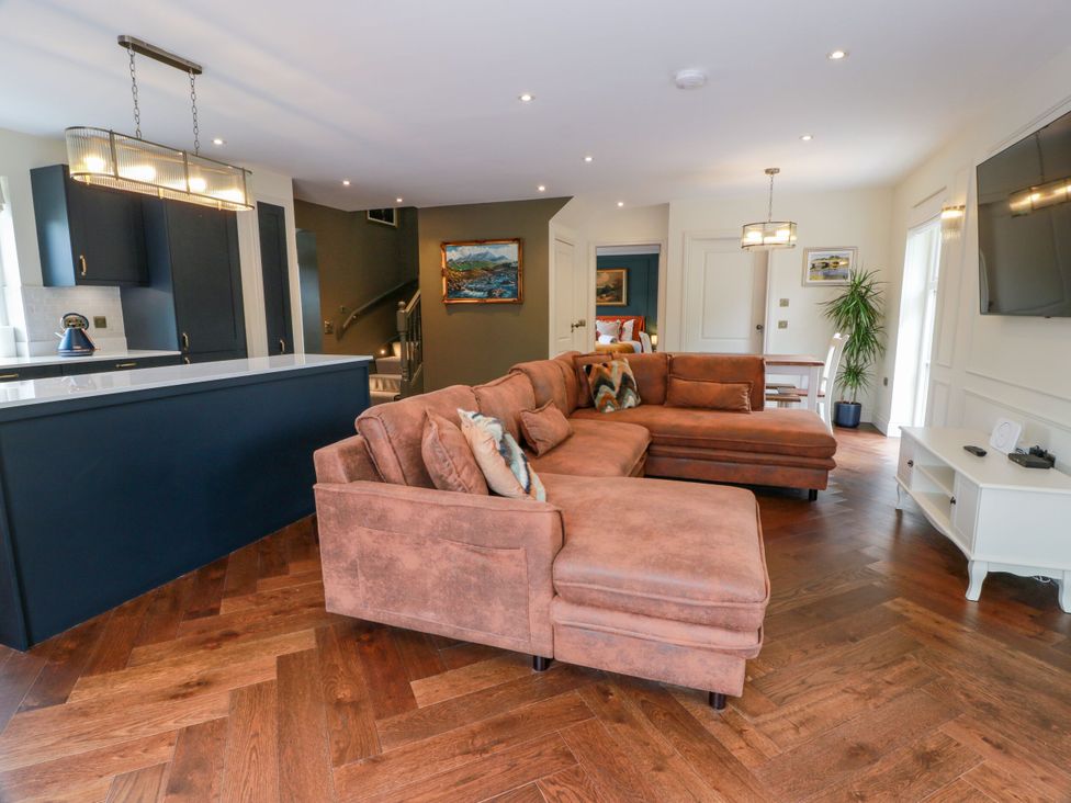 A living room with a sofa and television at Riverwood House in Gatehouse Of Fleet