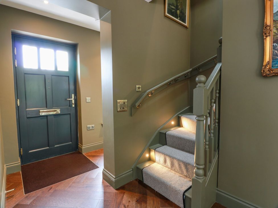 A hallway with a front door and staircase at Riverwood House Gatehouse Of Fleet