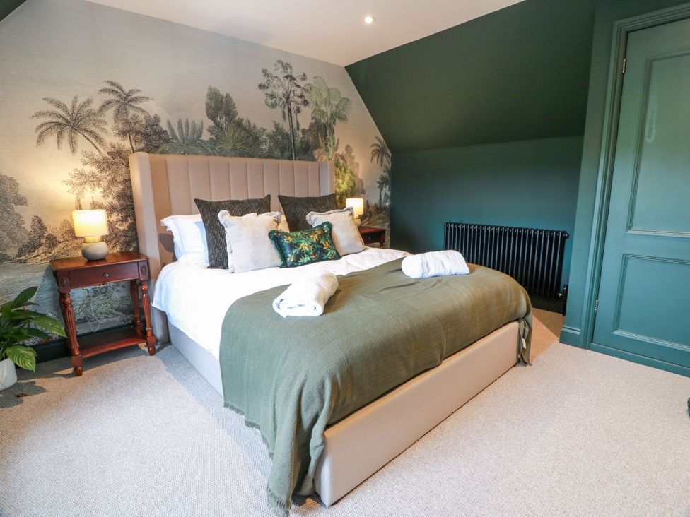 A bedroom with a bed and nightstand at Riverwood House Gatehouse Of Fleet