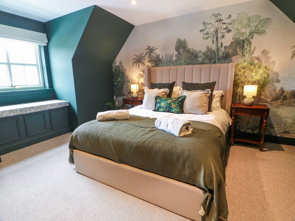 A bedroom with a bed and decorative mural at Riverwood House Gatehouse Of Fleet