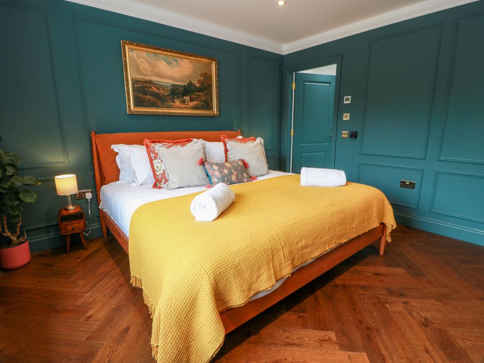 A bedroom with a bed and a painting at Riverwood House Gatehouse Of Fleet