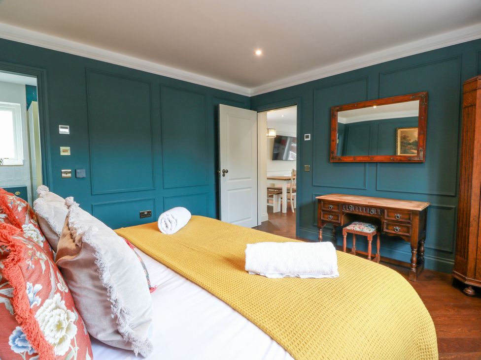 A bedroom with a bed and a wooden table at Riverwood House in Gatehouse Of Fleet