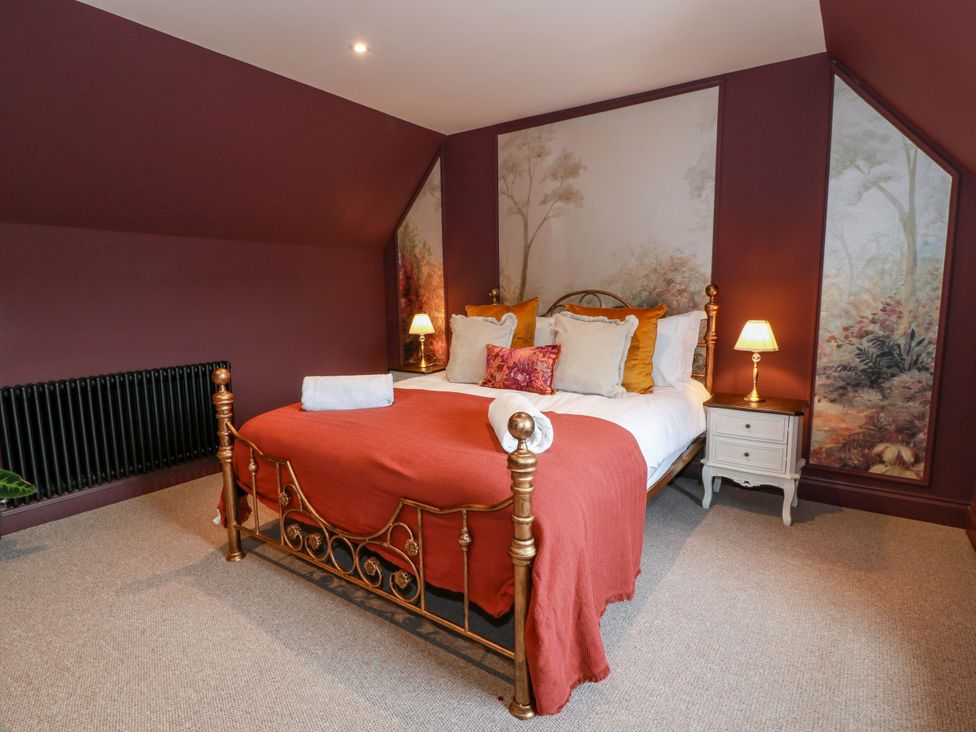 A bedroom with a bed and bedside table at Riverwood House Gatehouse Of Fleet