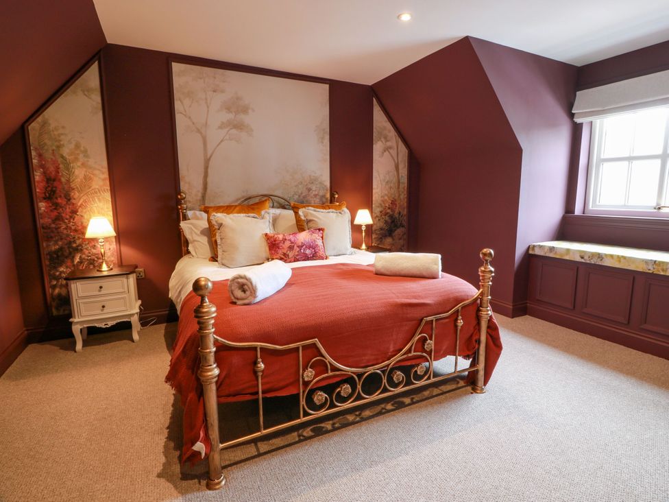 A bedroom with a bed and nightstand at Riverwood House Gatehouse Of Fleet