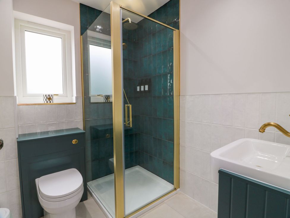 A bathroom with a shower, toilet, and sink at Riverwood House Gatehouse Of Fleet