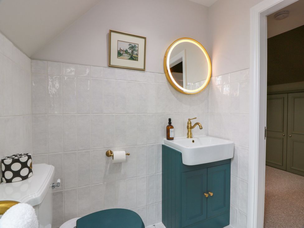 A bathroom with a sink and toilet at Riverwood House, Gatehouse Of Fleet