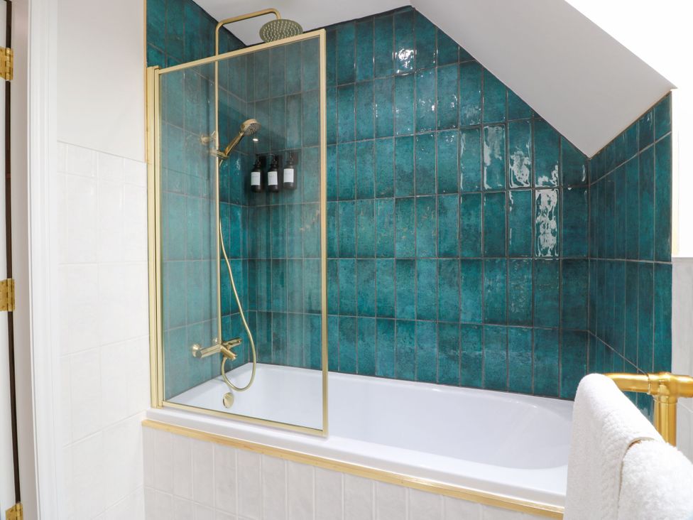 A bathroom with a bathtub and shower at Riverwood House in Gatehouse Of Fleet