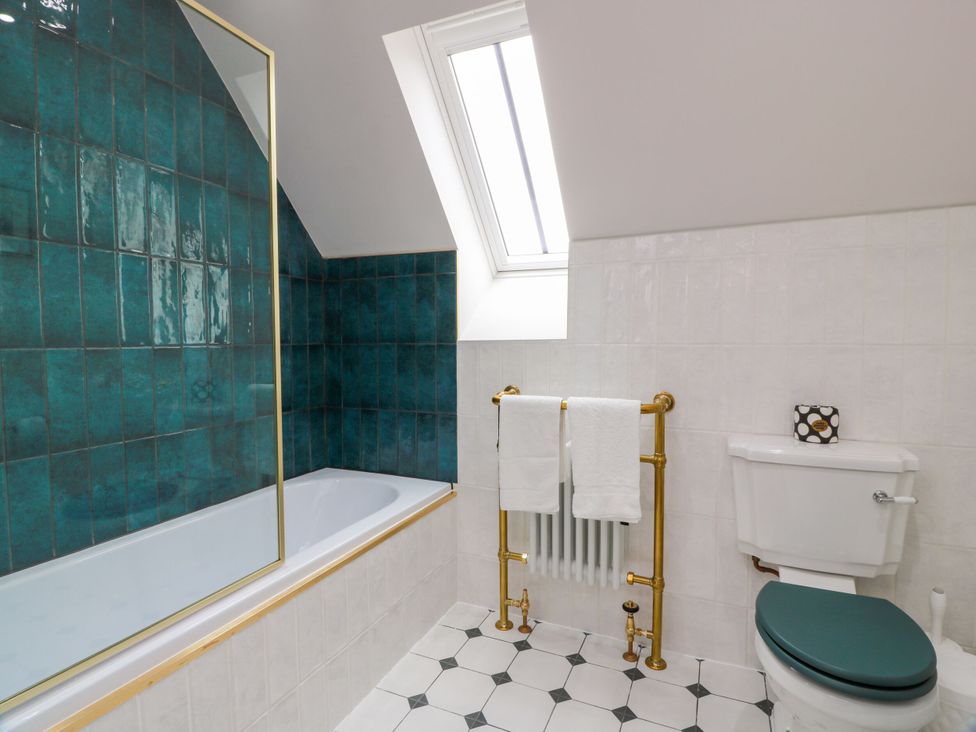 A bathroom with a bathtub and toilet at Riverwood House Gatehouse Of Fleet