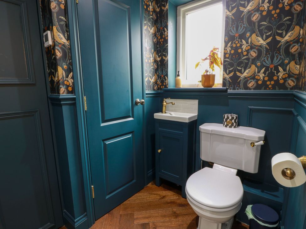 A bathroom with a toilet and washbasin at Riverwood House in Gatehouse Of Fleet