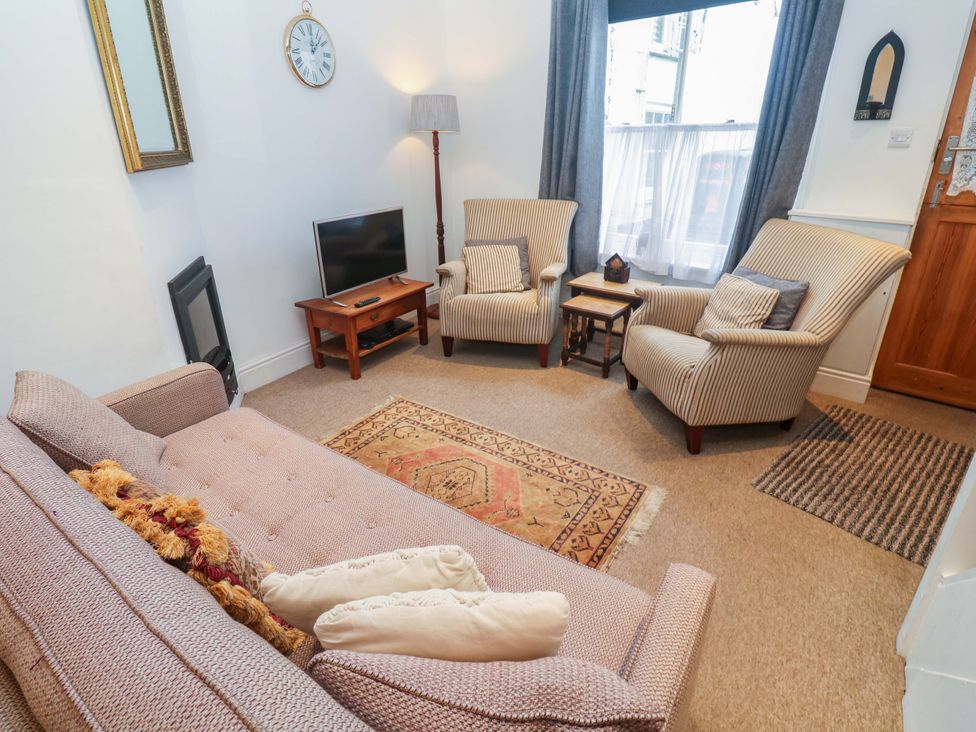A living room with a sofa and armchairs at Pelican Cottage in St Ives