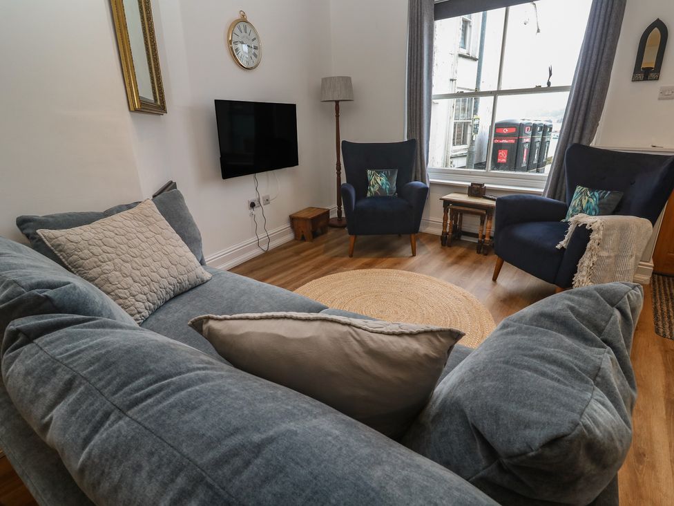 A living room with a sofa and armchairs at Pelican Cottage in St Ives