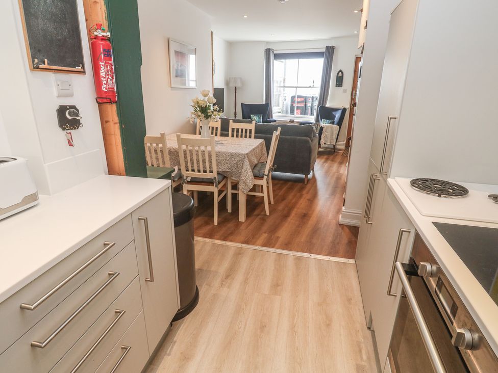 A kitchen area leading to a dining area at Pelican Cottage St Ives