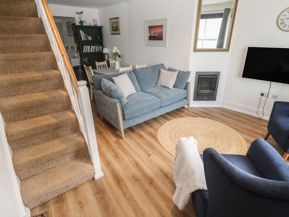 A living room with a sofa and armchairs at Pelican Cottage in St Ives