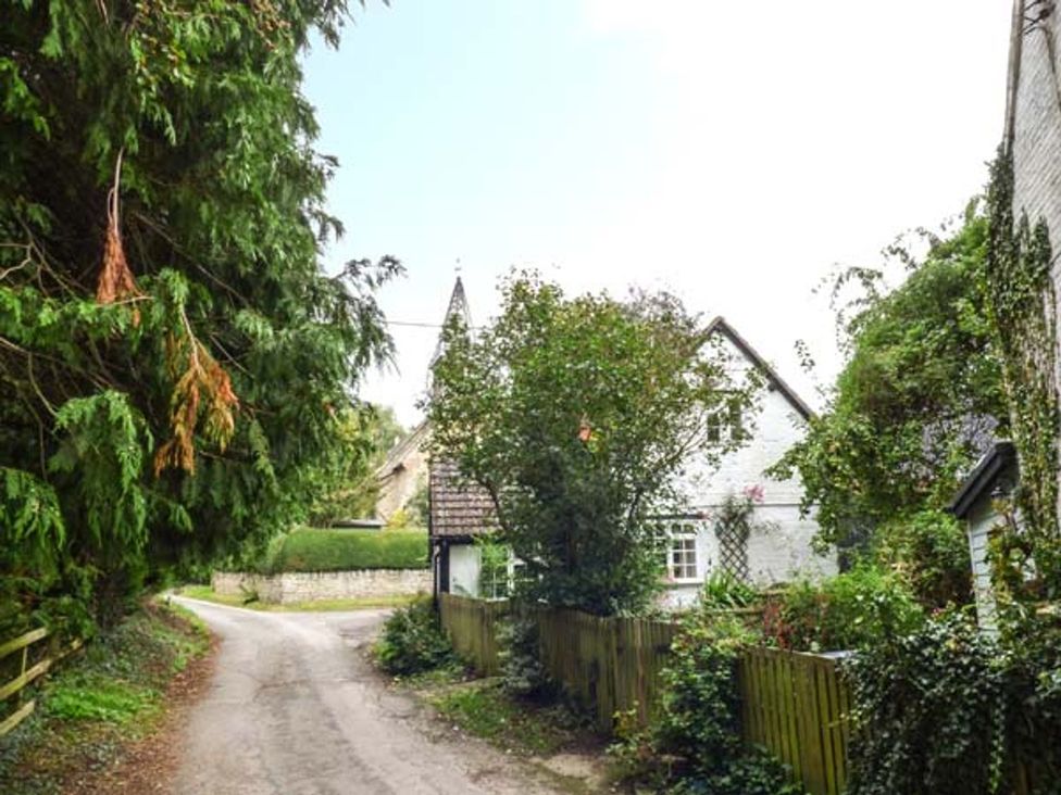 A view of a road with trees and a house at The Smithy in Lucton near Mortimers Cross
