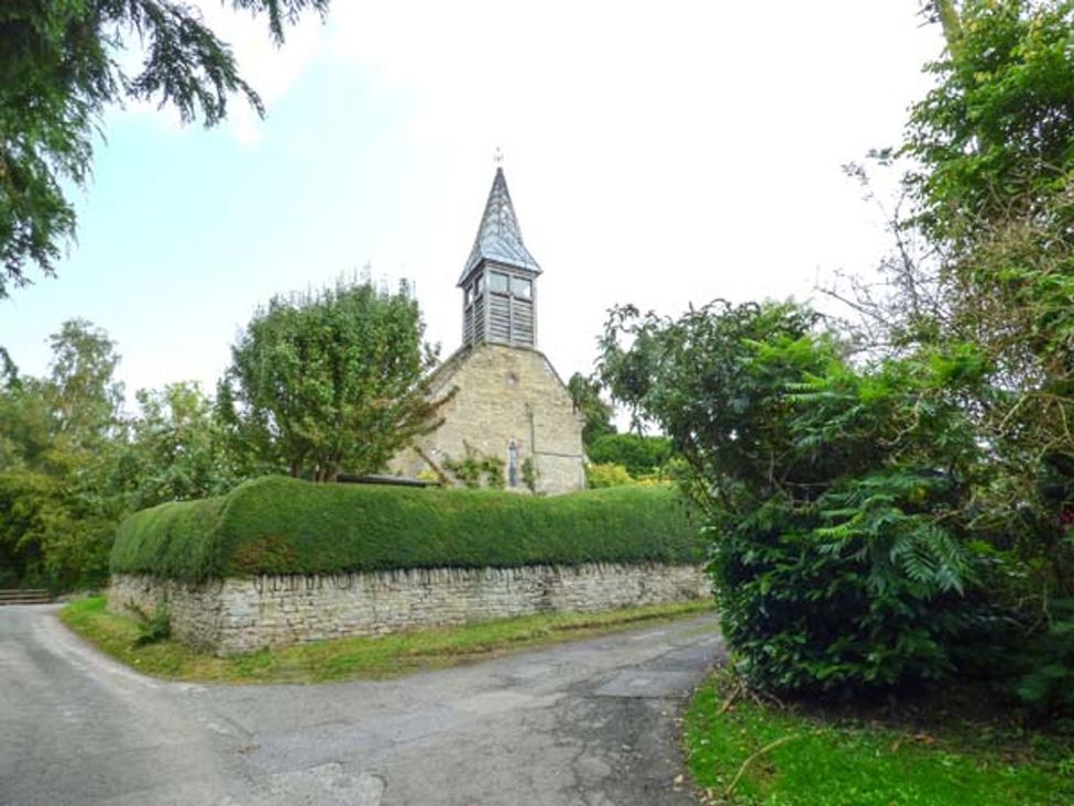 A building with a steeple near a road at The Smithy in Lucton near Mortimers Cross