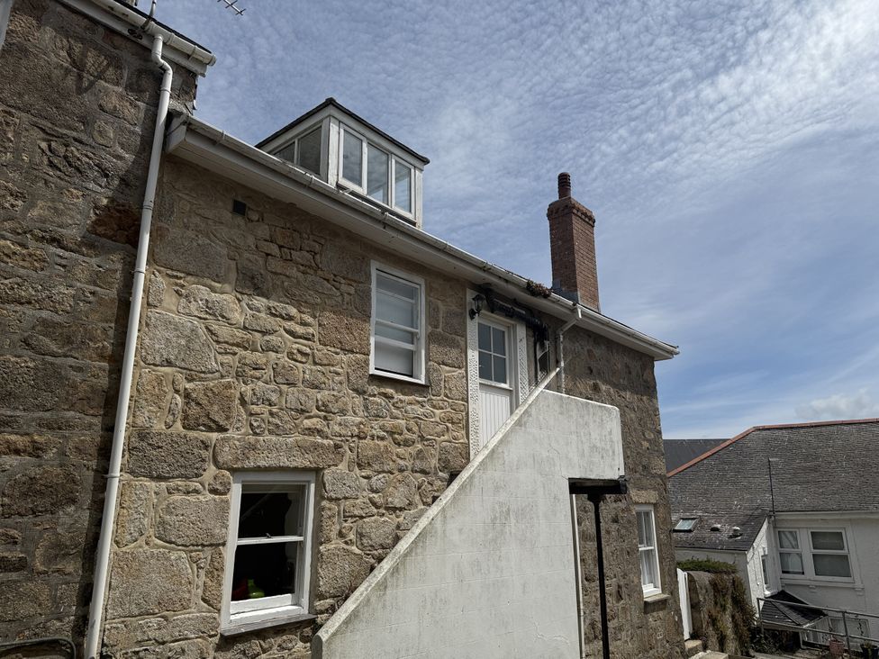 A building with stone walls and windows at Crows Nest in St Ives
