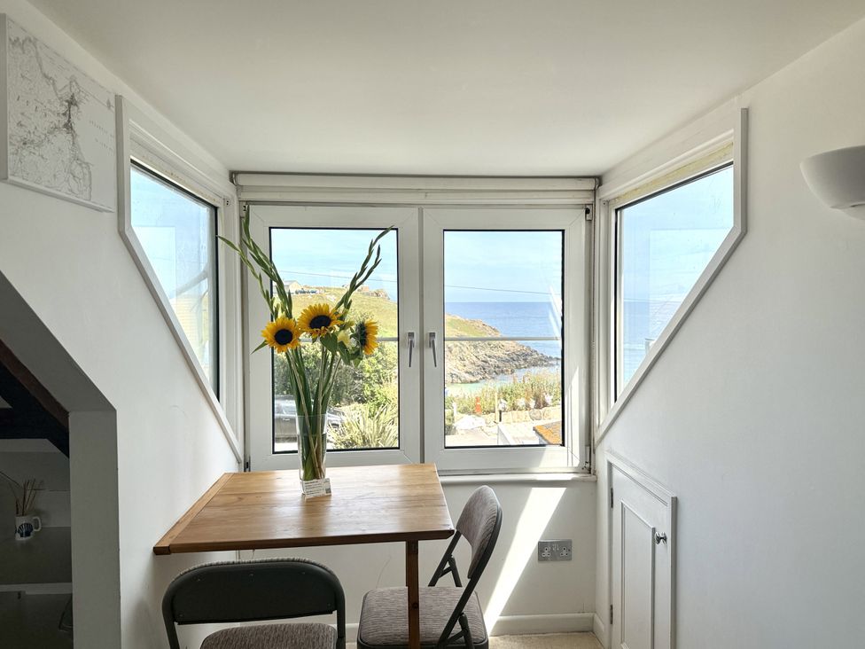 A dining area with a table and chairs at Crows Nest in St Ives