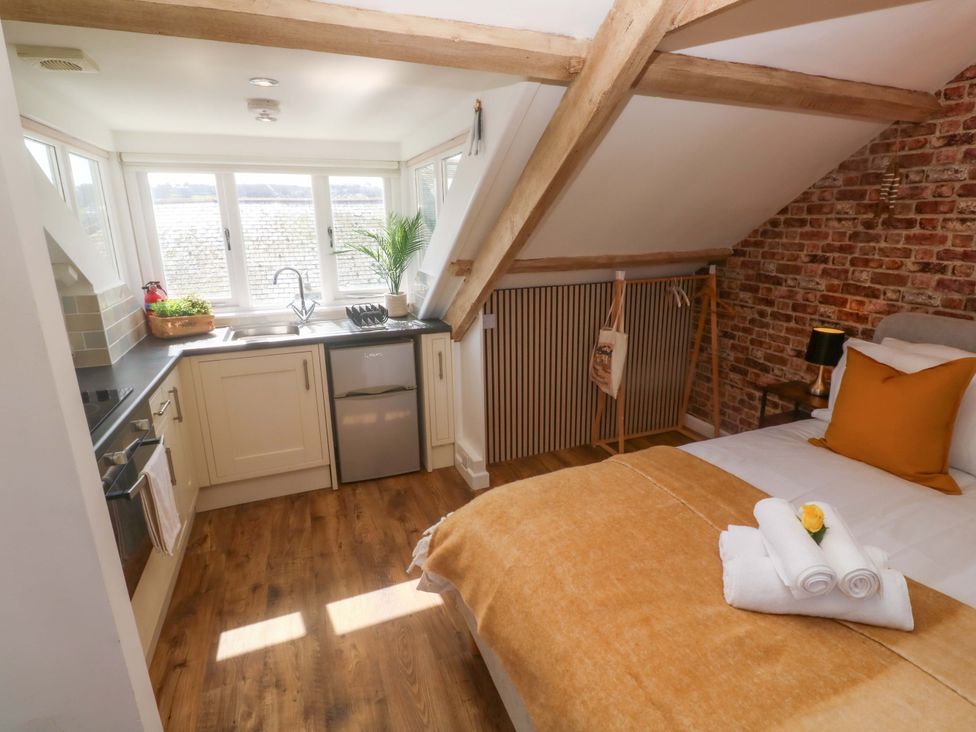 A bedroom with a kitchen area at Seagulls Nest in St Ives