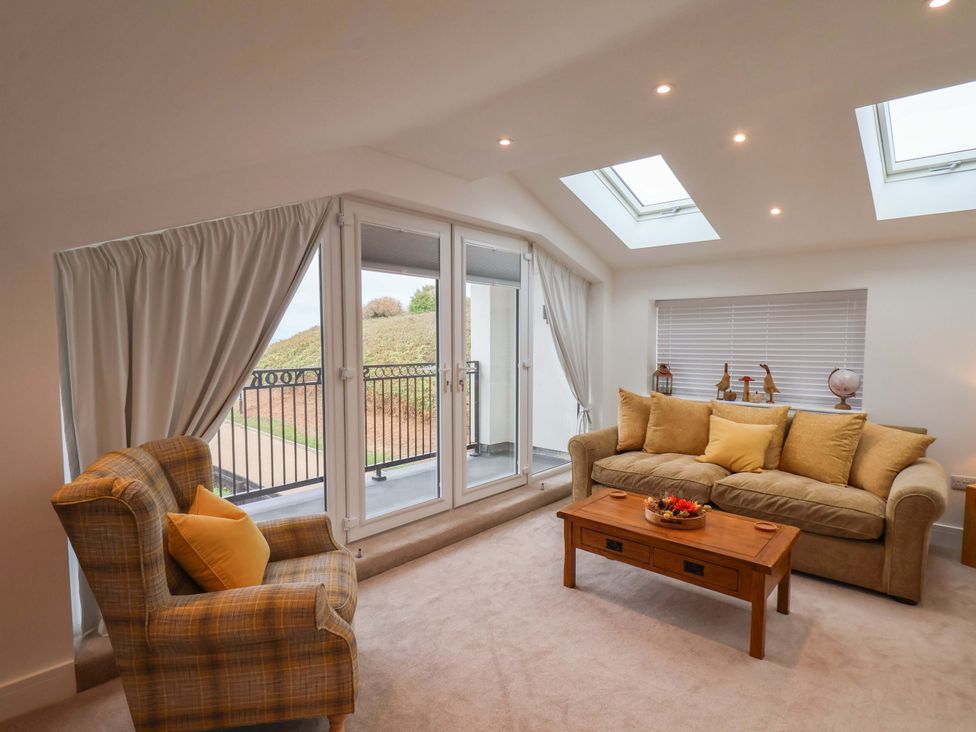 A living room with a sofa and armchair at Sandy Nook in Redcar