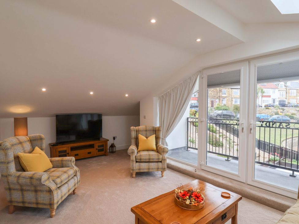 A living room with a TV and seating area at Sandy Nook in Redcar