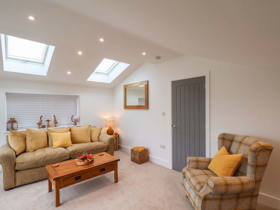 A living room with a sofa and coffee table at Sandy Nook in Redcar