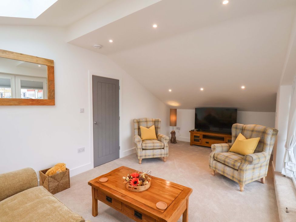 A living room with two armchairs and a television at Sandy Nook in Redcar