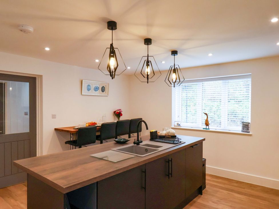A kitchen with an island and seating at Sandy Nook in Redcar