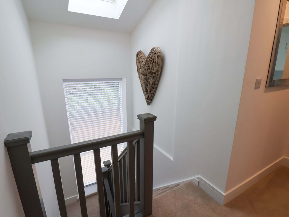 A stairwell with a window and heart decoration at Sandy Nook in Redcar