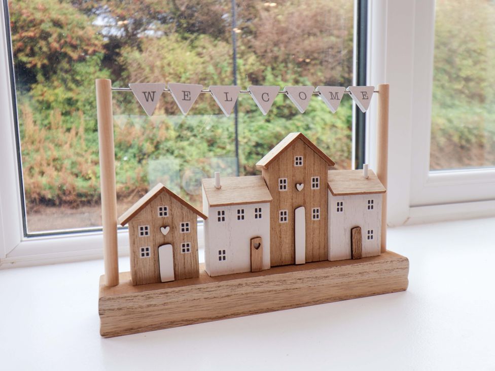 A wooden house decoration with a welcome sign at Sandy Nook in Redcar