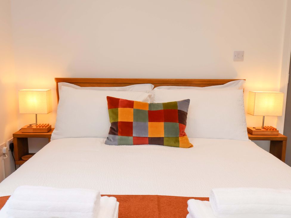 A bedroom with a bed and bedside lamps at Sandy Nook in Redcar