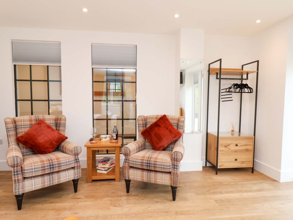 A living room with two armchairs and a side table at Sandy Nook in Redcar