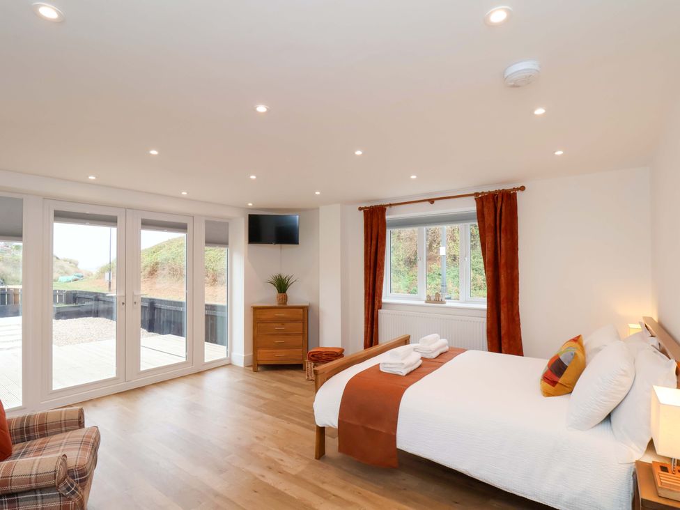 A bedroom with a bed and window at Sandy Nook in Redcar