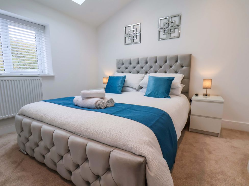A bedroom with a double bed and bedside tables at Sandy Nook in Redcar