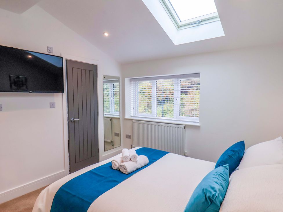 A bedroom with a bed and television at Sandy Nook in Redcar