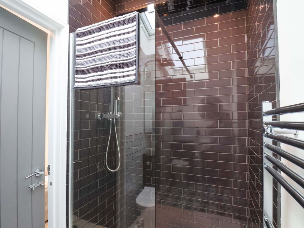 A bathroom with a shower and towel rack at Sandy Nook in Redcar
