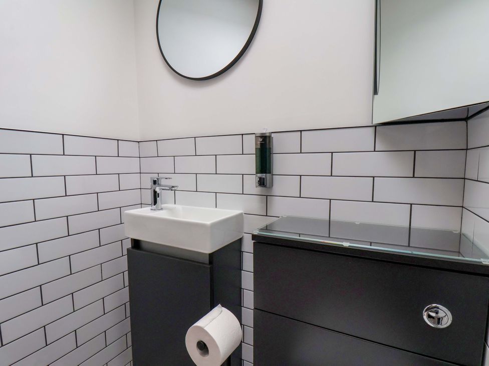 A bathroom with a sink and mirror at Sandy Nook in Redcar