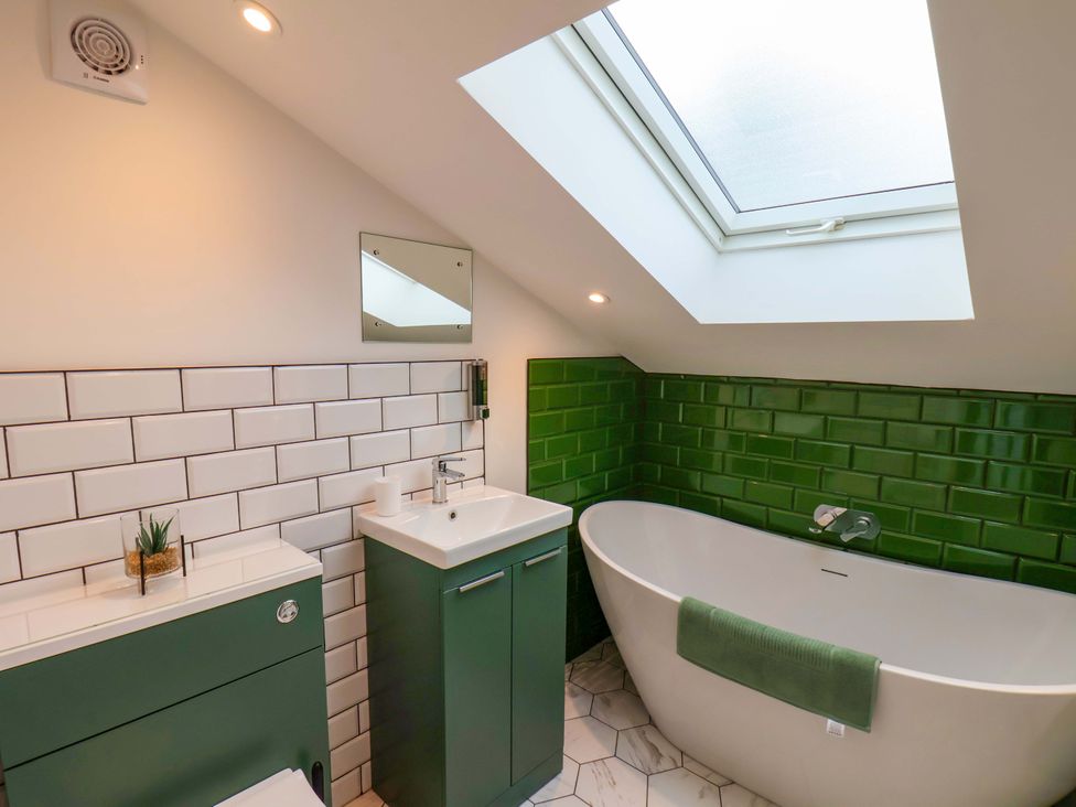 A bathroom with a toilet, sink, and bathtub at Sandy Nook in Redcar